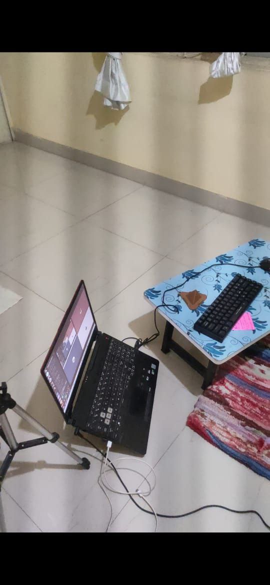 A makeshift laptop setup on the floor
